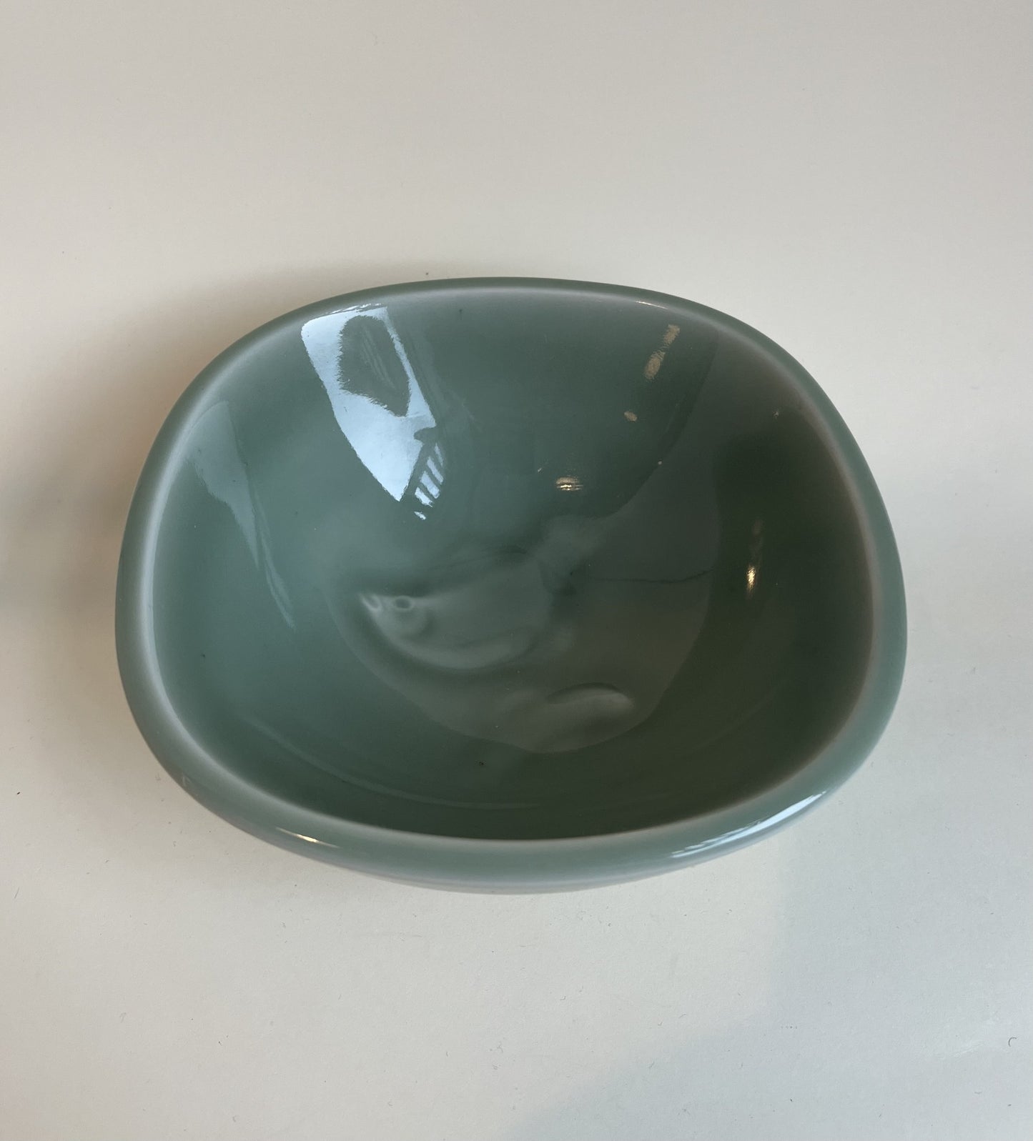 Royal Copenhagen bowl by Nils Thorsson with celadon glaze and fish at the bottom - no. 1010